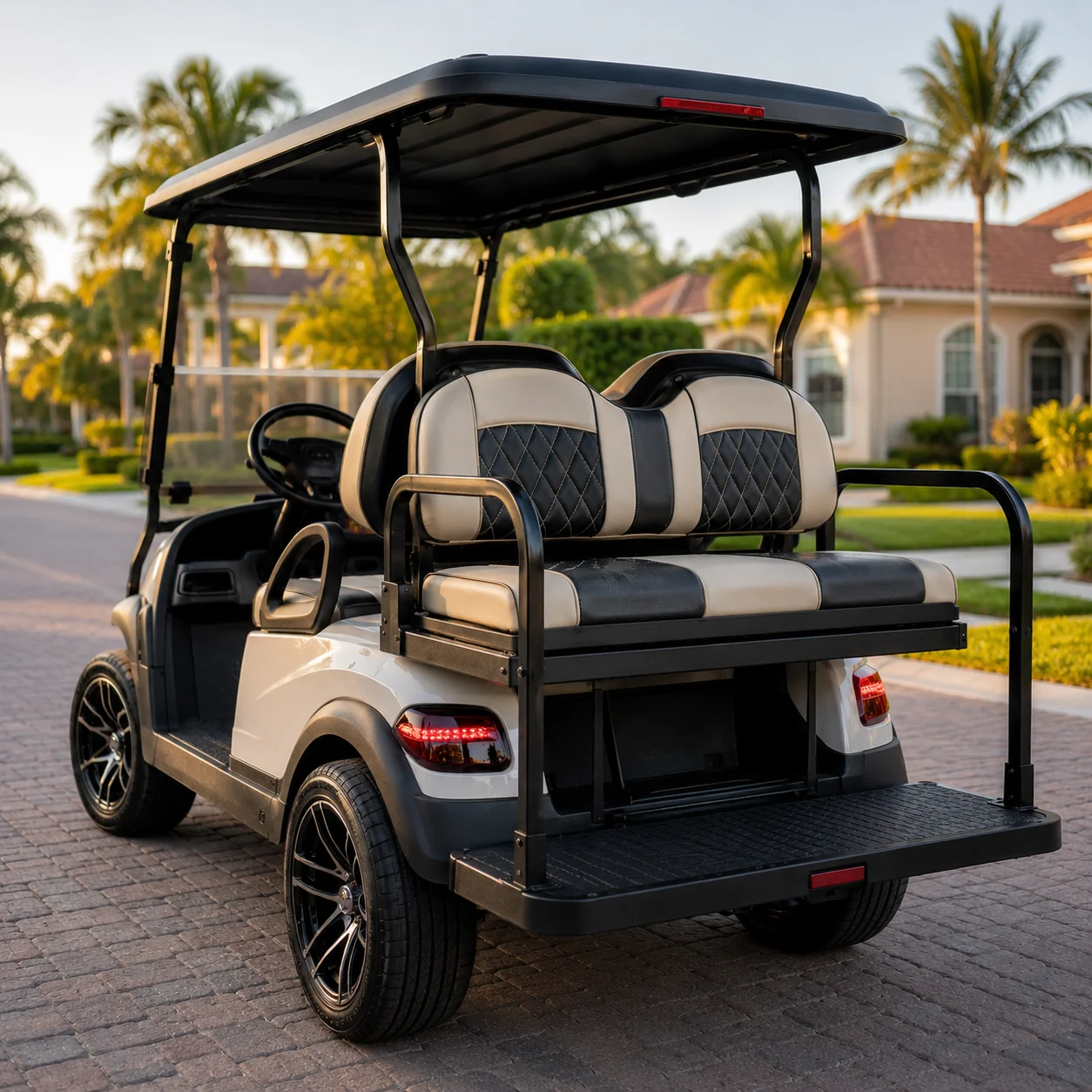 Custom golf cart with white and black upholstery parked in The Villages driveway, palm trees visible.